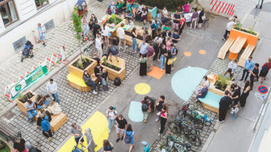 Viyana'da bir sokak etkinliğinde bir araya gelen mahalle sakinleri ve ahşap oturma alanları.