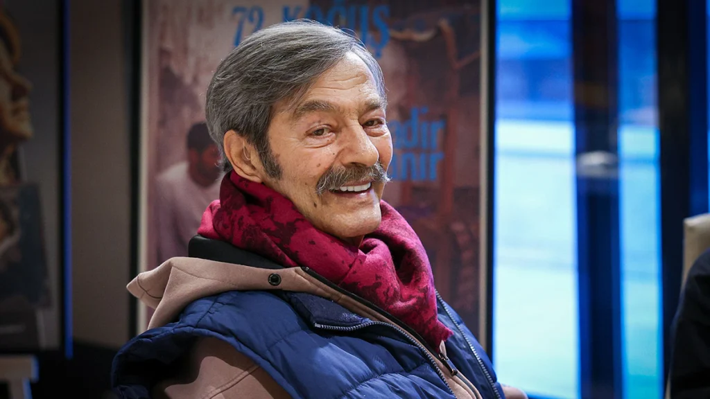 Usta sanatçı Kadir İnanır'ın gülümserken çekilmiş yakın plan portre fotoğrafı.